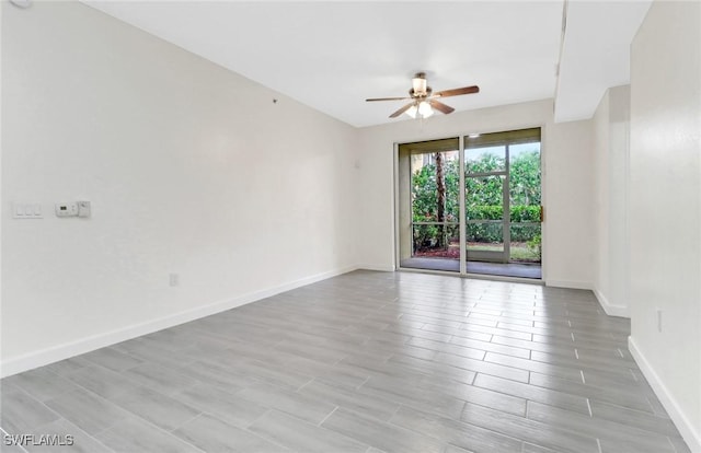 unfurnished room with ceiling fan, light wood-style floors, and baseboards