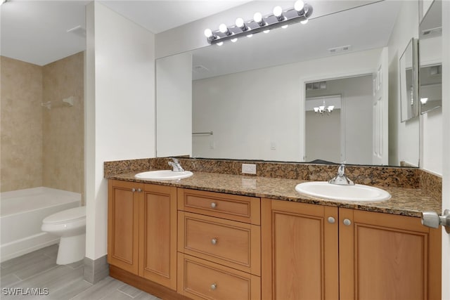 full bathroom with a sink, visible vents, toilet, and double vanity
