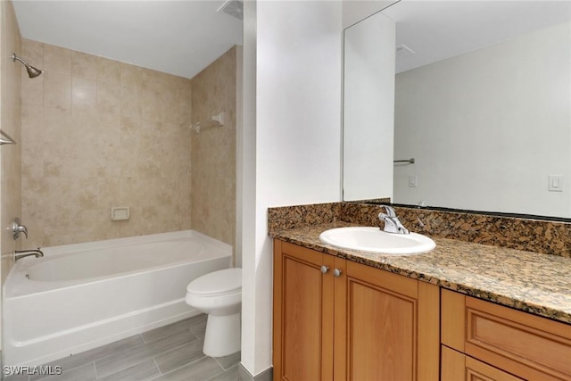 full bath featuring visible vents, toilet, vanity, and shower / washtub combination