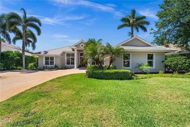 3911 Lakemont Dr, Bonita Springs, FL 34134 - single story home featuring stucco siding, a front lawn, and decorative driveway