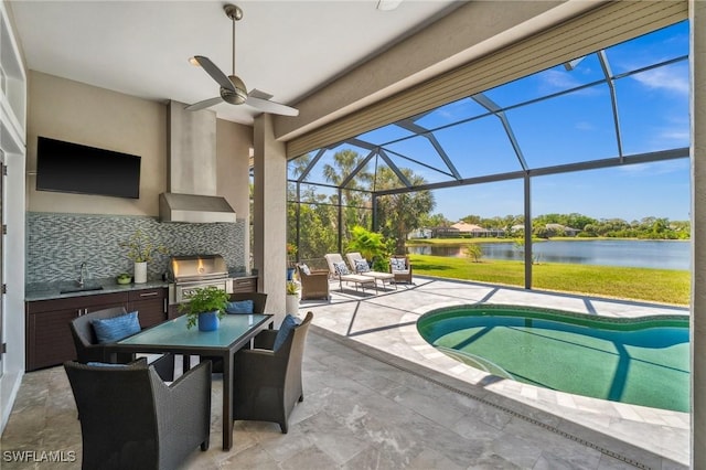 3911 Lakemont Dr, Bonita Springs, FL 34134 - pool featuring a water view, a grill, a sink, an outdoor kitchen, and a patio area