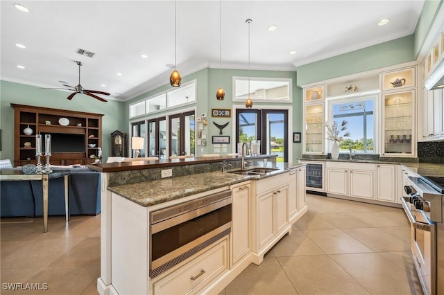 3911 Lakemont Dr, Bonita Springs, FL 34134 - kitchen with light tile patterned floors, wine cooler, a sink, visible vents, and appliances with stainless steel finishes