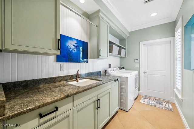 3911 Lakemont Dr, Bonita Springs, FL 34134 - clothes washing area featuring crown molding, light tile patterned floors, separate washer and dryer, a sink, and cabinet space