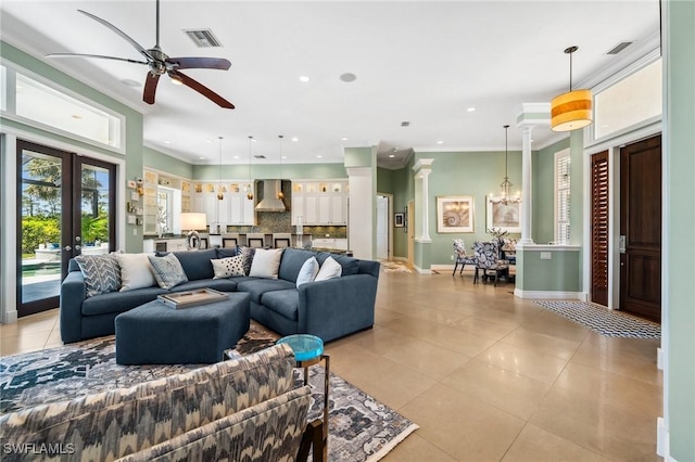 3911 Lakemont Dr, Bonita Springs, FL 34134 - living room with light tile patterned floors, visible vents, crown molding, and ceiling fan with notable chandelier