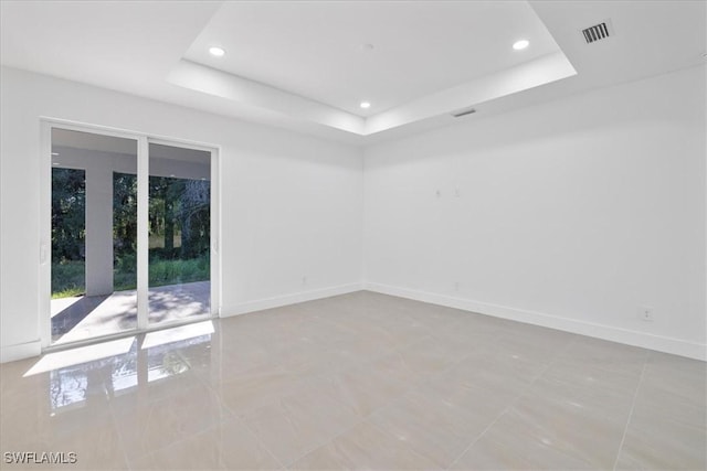 150 Bell Blvd S, Lehigh Acres, FL 33974 - unfurnished room with a tray ceiling, baseboards, and visible vents