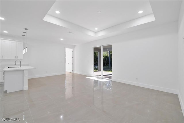 150 Bell Blvd S, Lehigh Acres, FL 33974 - empty room featuring baseboards, recessed lighting, a sink, and a raised ceiling
