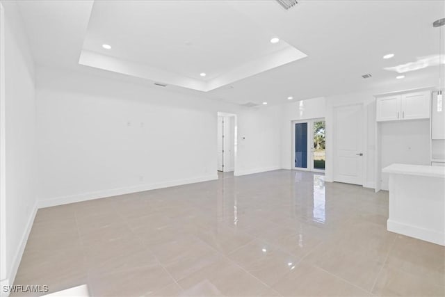 150 Bell Blvd S, Lehigh Acres, FL 33974 - spare room featuring a raised ceiling, baseboards, and recessed lighting