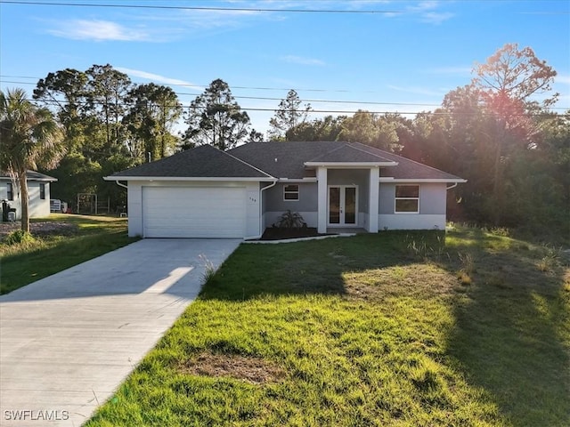150 Bell Blvd S, Lehigh Acres, FL 33974 - view of front of property featuring an attached garage, concrete driveway, a front yard, stucco siding, and french doors