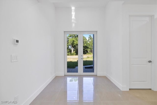 150 Bell Blvd S, Lehigh Acres, FL 33974 - doorway to outside featuring french doors, light tile patterned flooring, and baseboards