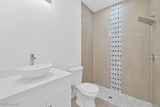 150 Bell Blvd S, Lehigh Acres, FL 33974 - bathroom with a tile shower, toilet, and vanity