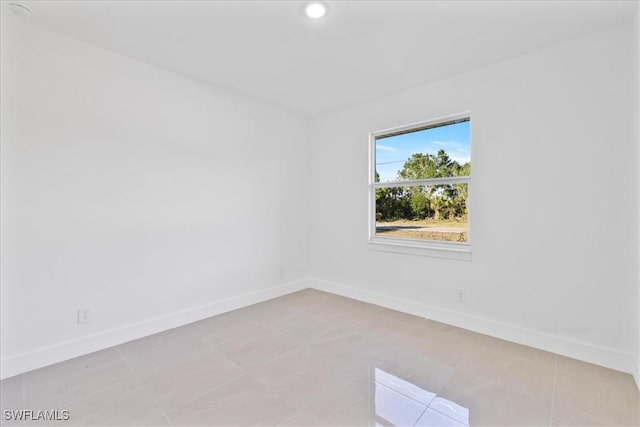150 Bell Blvd S, Lehigh Acres, FL 33974 - spare room featuring light tile patterned floors and baseboards