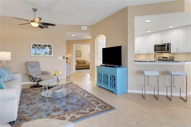 14561 Bellino Ter Unit 101, Bonita Springs, FL 34135 - living room featuring a ceiling fan, recessed lighting, arched walkways, and light tile patterned floors