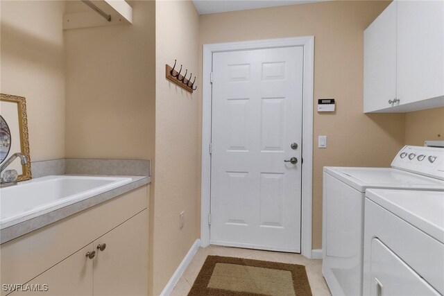 14561 Bellino Ter Unit 101, Bonita Springs, FL 34135 - laundry room with light tile patterned floors, cabinet space, baseboards, and washer and clothes dryer