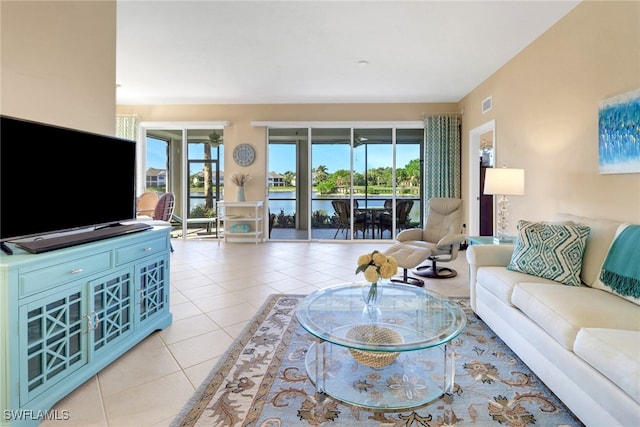 14561 Bellino Ter Unit 101, Bonita Springs, FL 34135 - living area with light tile patterned floors, a healthy amount of sunlight, and visible vents