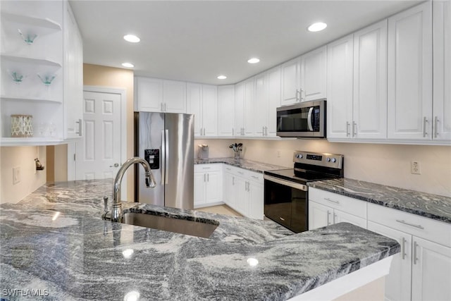 14561 Bellino Ter Unit 101, Bonita Springs, FL 34135 - kitchen featuring white cabinets, a sink, open shelves, and appliances with stainless steel finishes