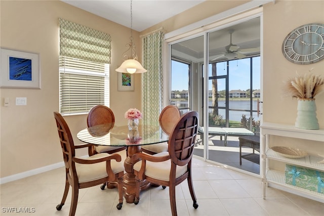 14561 Bellino Ter Unit 101, Bonita Springs, FL 34135 - dining room featuring baseboards, a water view, tile patterned floors, and a ceiling fan