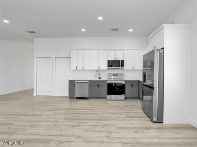 633 Cane St E, Lehigh Acres, FL 33974 - kitchen with appliances with stainless steel finishes, a sink, gray cabinetry, recessed lighting, and light wood-style floors
