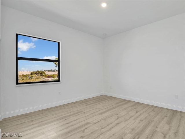 633 Cane St E, Lehigh Acres, FL 33974 - empty room with light wood-style flooring, baseboards, and recessed lighting