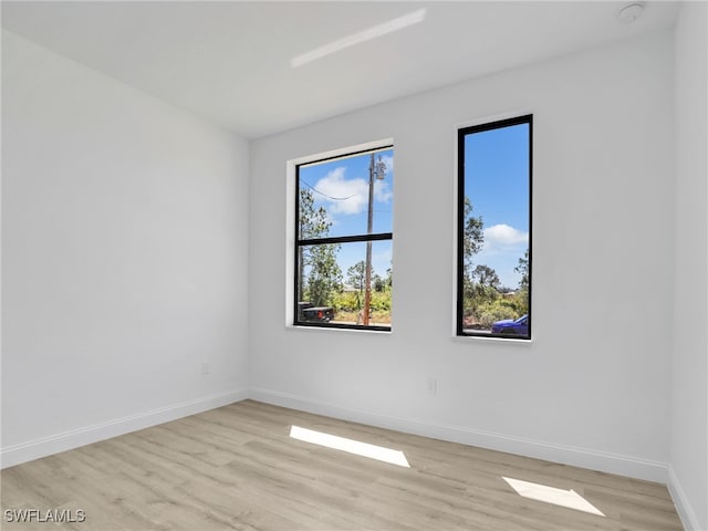 633 Cane St E, Lehigh Acres, FL 33974 - unfurnished room with light wood-style flooring, baseboards, and a smoke detector