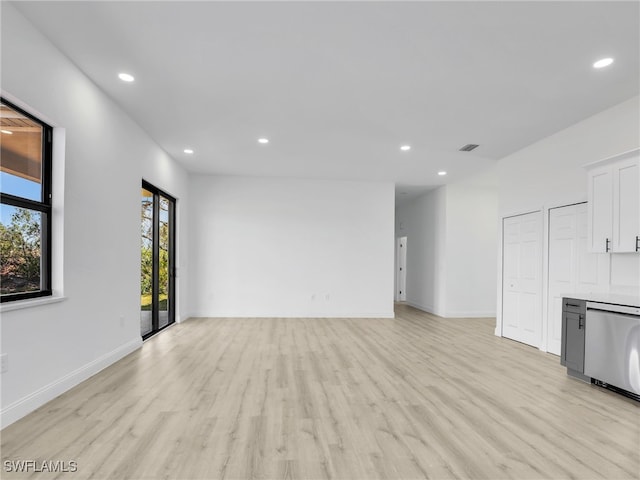 633 Cane St E, Lehigh Acres, FL 33974 - unfurnished living room featuring light wood finished floors, recessed lighting, and baseboards