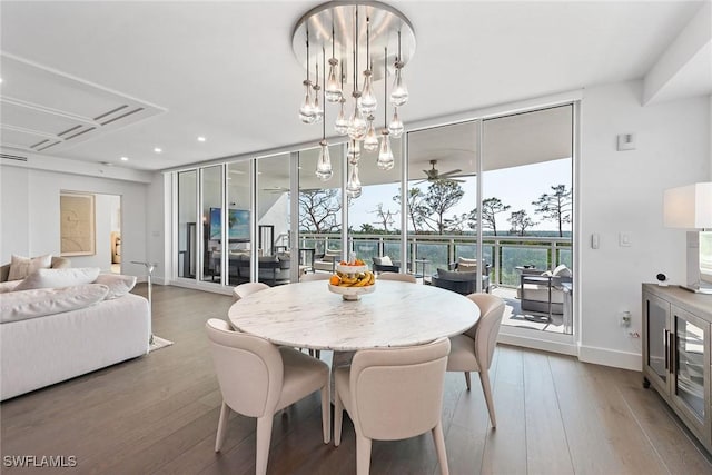 dining area with expansive windows, wood finished floors, recessed lighting, and baseboards