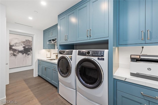 laundry room with a sink, washer and dryer, dark wood-style floors, and recessed lighting