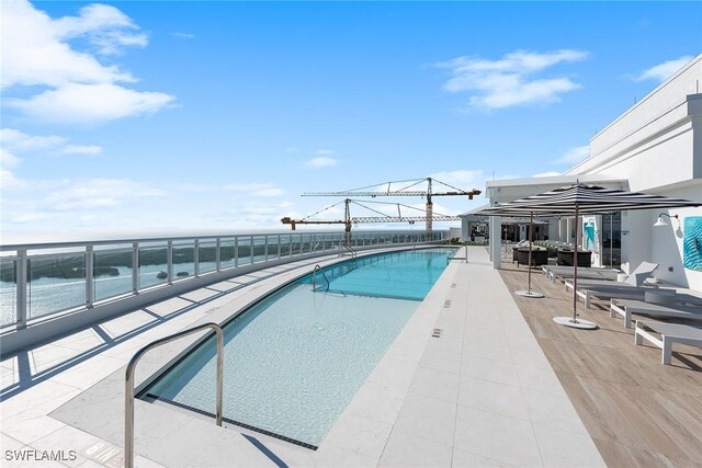 13945 Old Coast Rd Unit 406, Naples, FL 34110 - community pool with a water view and a patio area