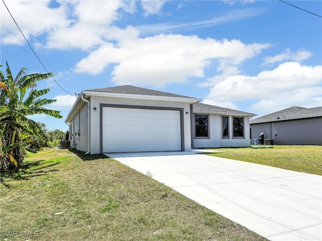 1134 Cumming St E, Lehigh Acres, FL 33974 - view of front of property featuring concrete driveway, stucco siding, central AC, and a garage