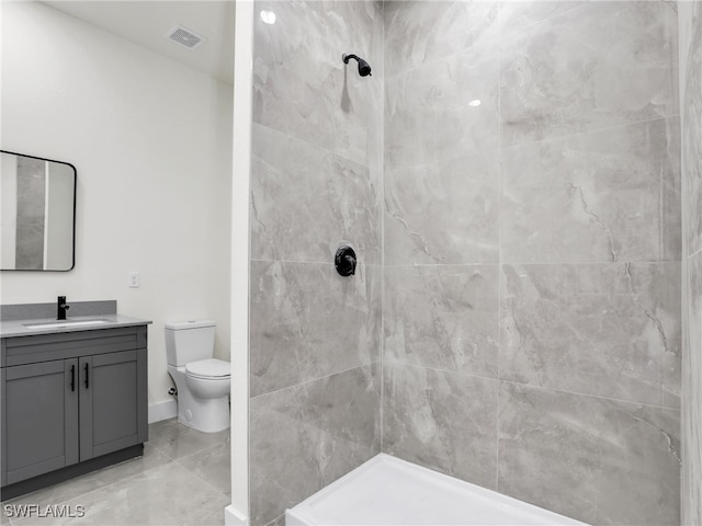 1134 Cumming St E, Lehigh Acres, FL 33974 - bathroom featuring toilet, vanity, and a tile shower