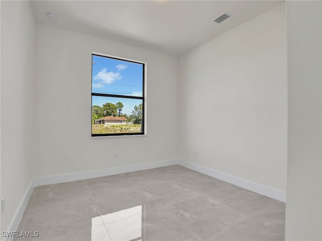 1134 Cumming St E, Lehigh Acres, FL 33974 - spare room with baseboards, a smoke detector, and light marble finish floors