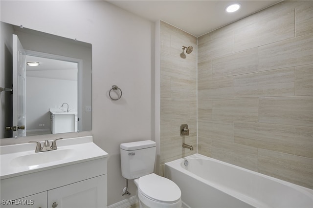 bathroom featuring toilet, vanity, and shower / tub combination