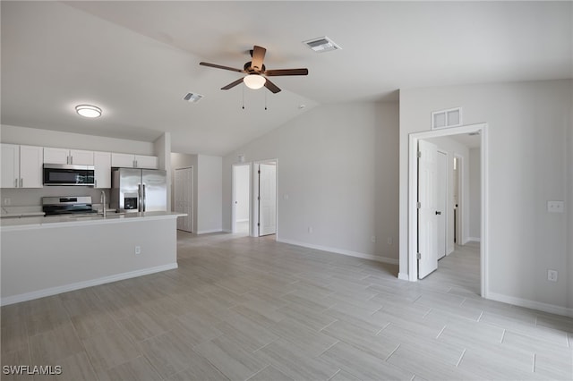 kitchen with ceiling fan, visible vents, stainless steel appliances, and open floor plan