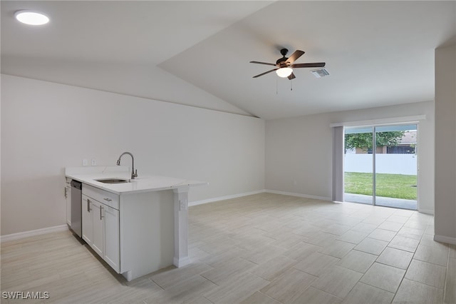 kitchen featuring visible vents, a ceiling fan, a sink, vaulted ceiling, and stainless steel dishwasher