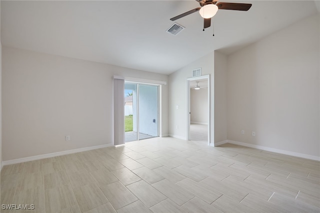empty room featuring baseboards, visible vents, and a ceiling fan