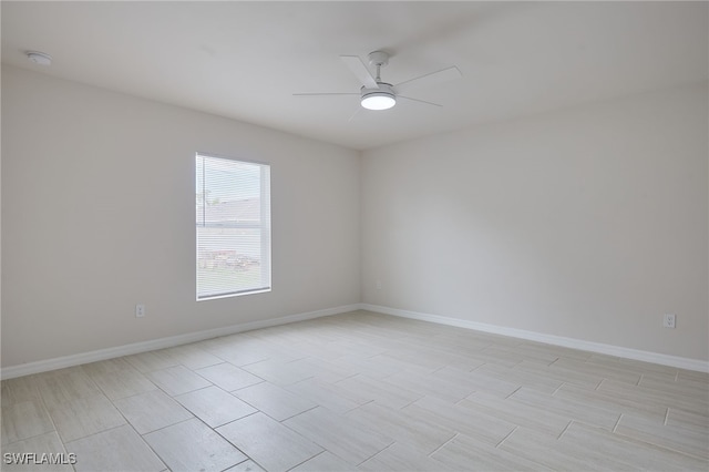 unfurnished room featuring baseboards and ceiling fan
