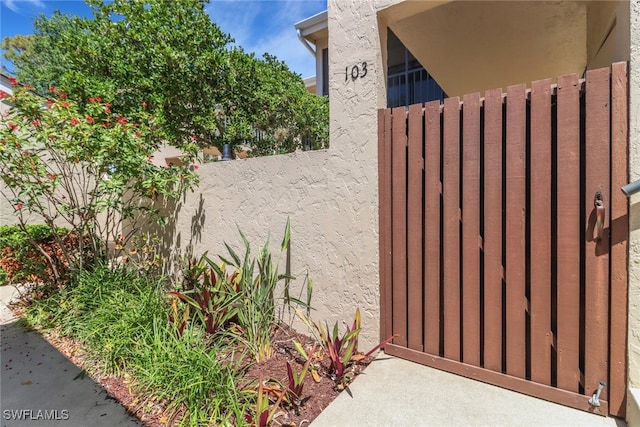 15450 Cedarwood Ln Unit 103, Naples, FL 34110 - view of gate featuring fence