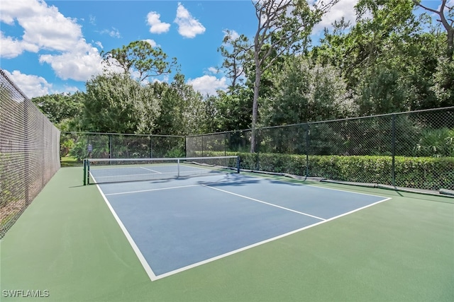 15450 Cedarwood Ln Unit 103, Naples, FL 34110 - view of tennis court featuring fence