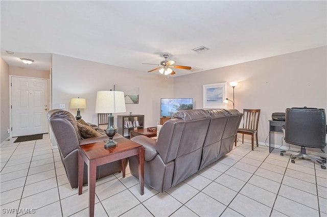 living room featuring baseboards, visible vents, a ceiling fan, and light tile patterned floors