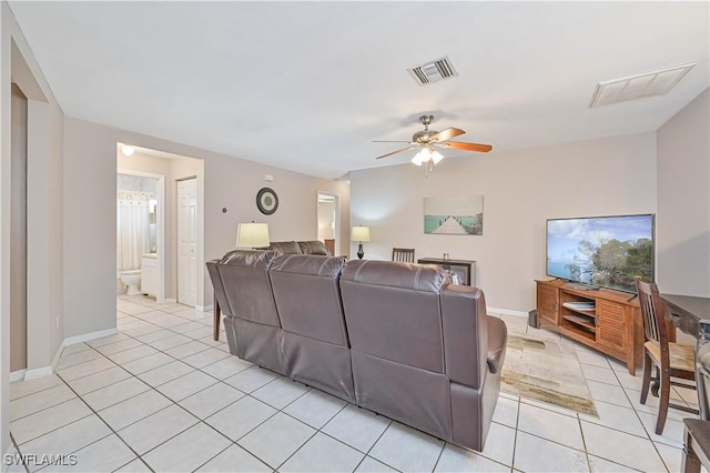 living room with baseboards, ceiling fan, visible vents, and light tile patterned floors
