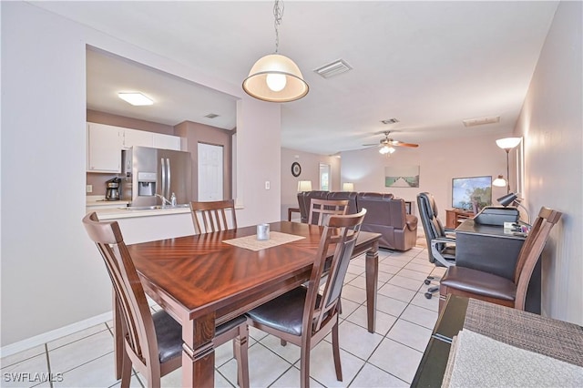 dining room featuring ceiling fan, visible vents, and light tile patterned floors