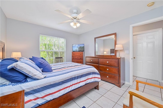 bedroom featuring a ceiling fan, light tile patterned floors, and baseboards