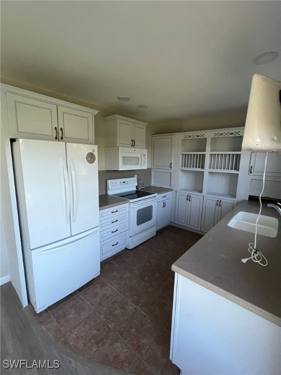 6824 Sandtrap Dr Unit 4, Fort Myers, FL 33919 - kitchen featuring white cabinets, a sink, open shelves, and white appliances