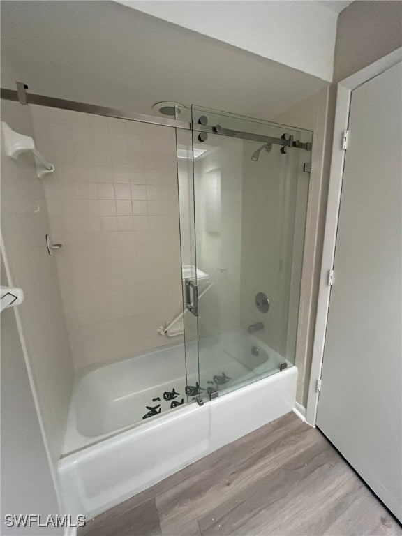 6824 Sandtrap Dr Unit 4, Fort Myers, FL 33919 - bathroom with shower / bath combination with glass door and wood finished floors