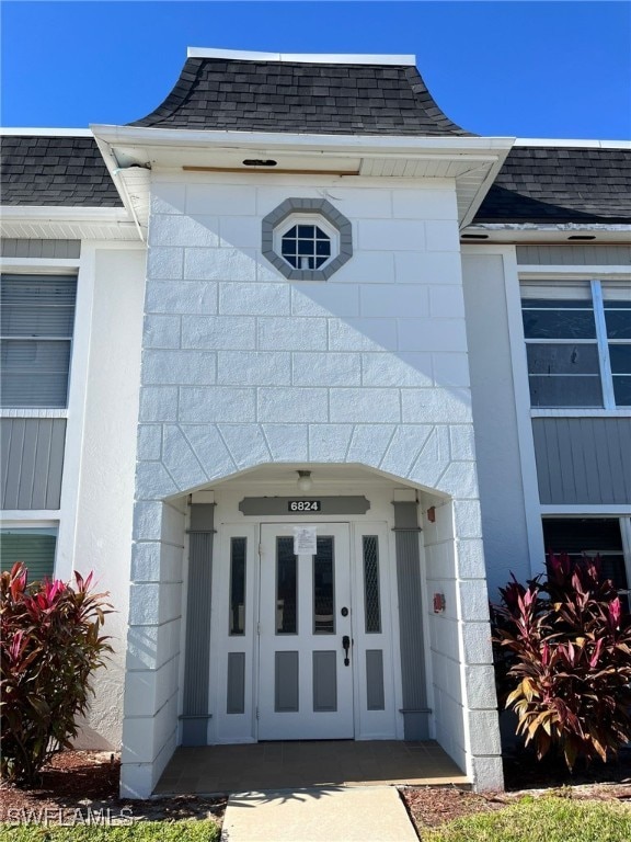 6824 Sandtrap Dr Unit 4, Fort Myers, FL 33919 - property entrance featuring a shingled roof