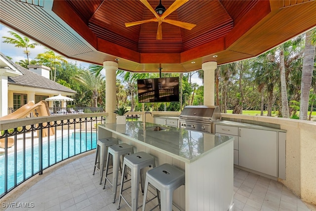 4300 Brynwood Dr, Naples, FL 34119 - view of patio with a grill, a sink, exterior kitchen, an outdoor pool, and a gazebo