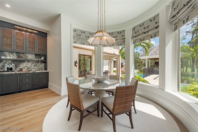 4300 Brynwood Dr, Naples, FL 34119 - dining room featuring indoor wet bar and light wood-style flooring
