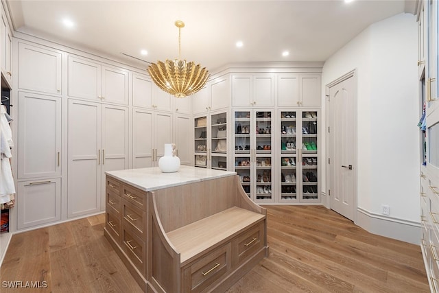 4300 Brynwood Dr, Naples, FL 34119 - walk in closet with a chandelier and light wood-style flooring