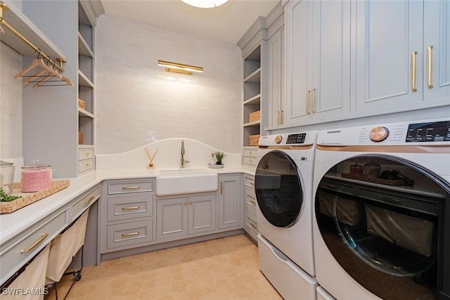 4300 Brynwood Dr, Naples, FL 34119 - laundry area featuring independent washer and dryer, a sink, light floors, and cabinet space