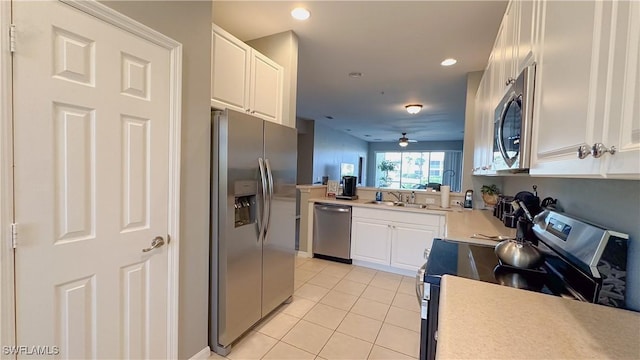 14512 Abaco Lakes Dr Unit 103, Fort Myers, FL 33908 - kitchen featuring light countertops, stainless steel appliances, light tile patterned flooring, ceiling fan, and white cabinets