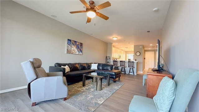 14512 Abaco Lakes Dr Unit 103, Fort Myers, FL 33908 - living room with baseboards, visible vents, light wood-type flooring, and a ceiling fan
